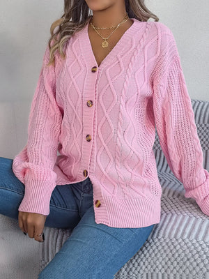 Blush pink cable knit cardigan with balloon sleeves and button front.