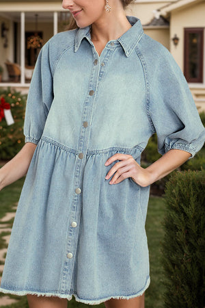 Light wash denim shirtdress with gathered yoke, button front, puff sleeves, and frayed hem.