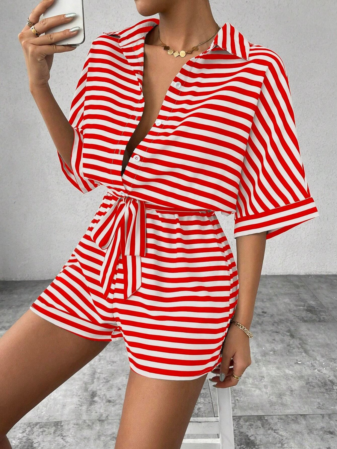 Red and white striped shirt romper with self-tie belt and button front.