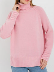 Blush pink cashmere turtleneck sweater with raglan sleeves and ribbed cuffs and hem.