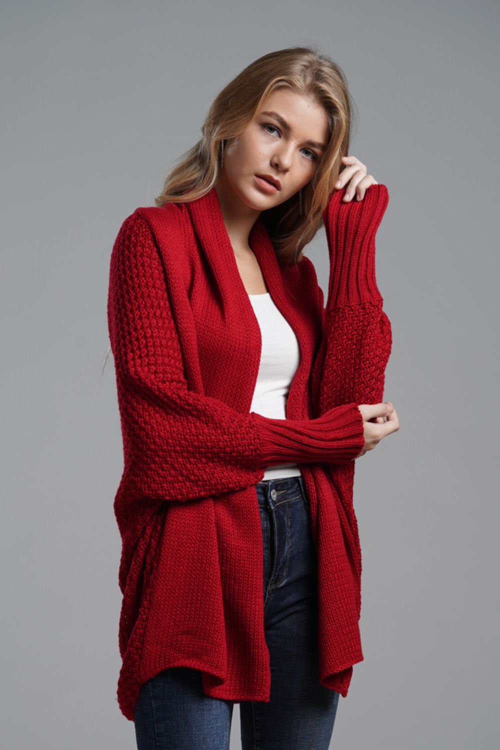 Red knit batwing cardigan with textured sleeves and draped front