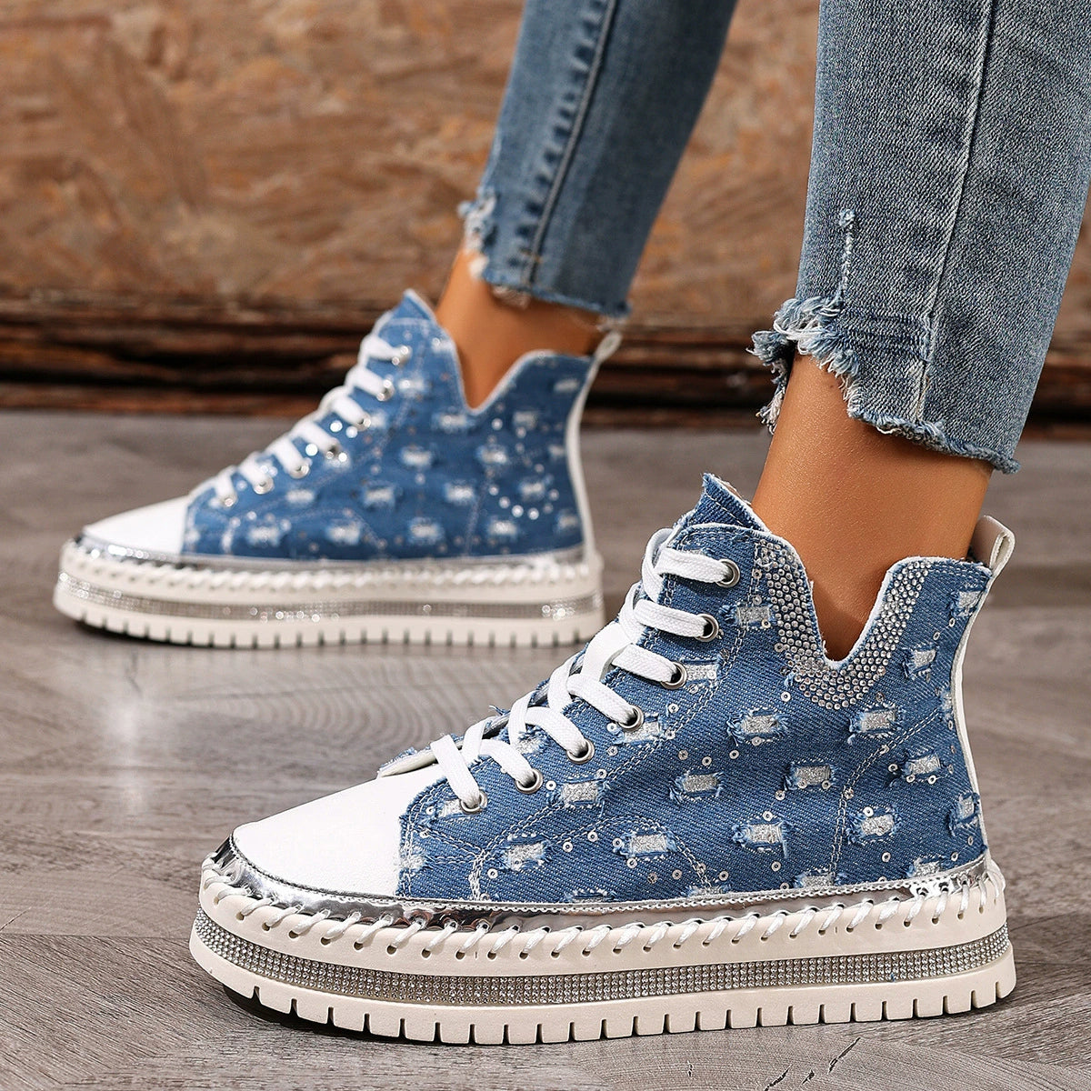 Blue denim high-top sneakers with rhinestone embellishments and a chunky sole.