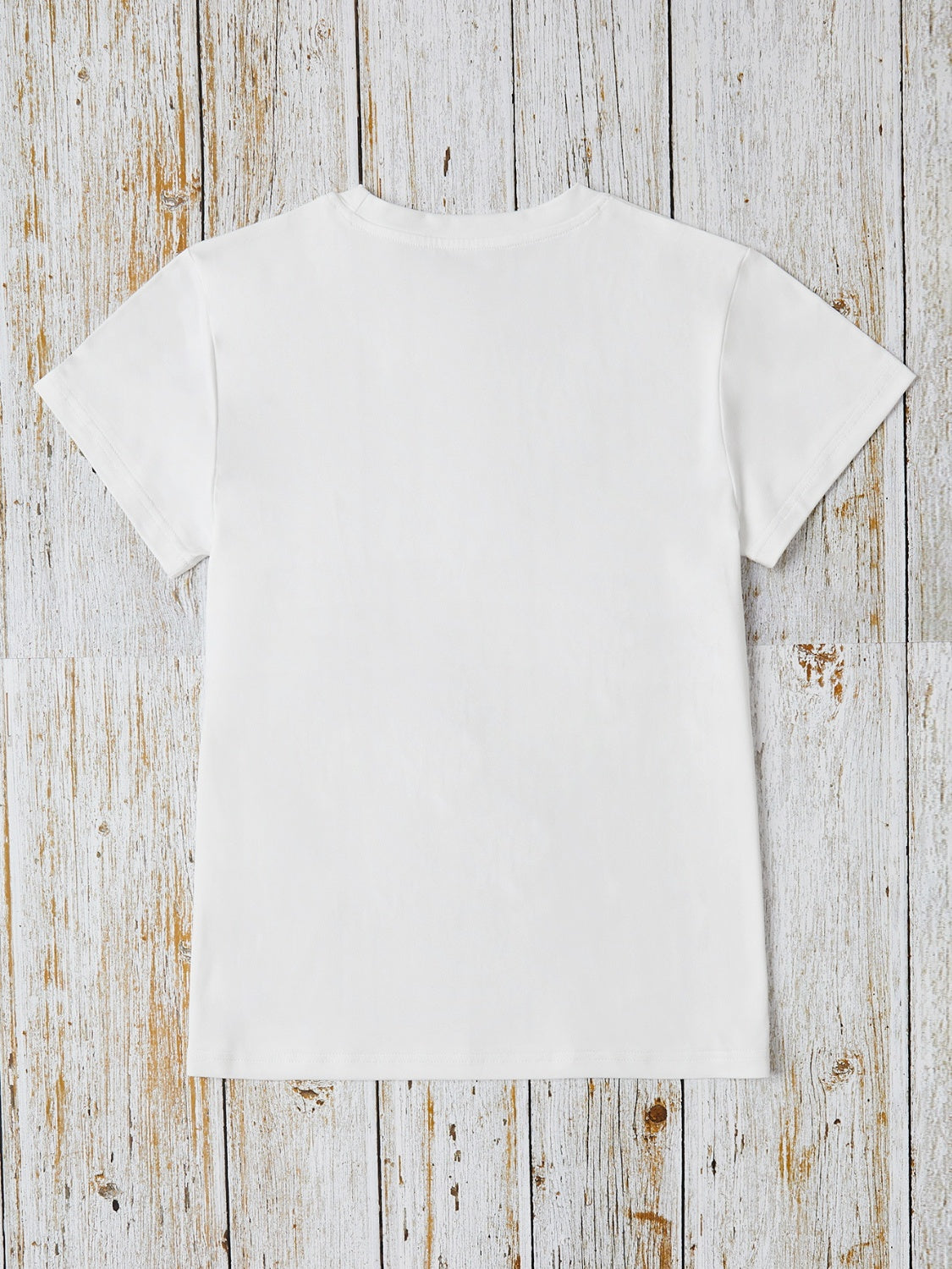 White crew neck t-shirt with short sleeves and a relaxed fit.