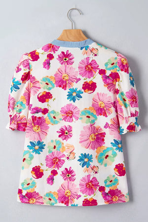 Vibrant floral print cotton blouse with blue striped collar and smocked cuffs.