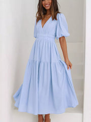 Light blue midi dress with V-neck, puff sleeves, cinched waist, and tiered skirt.