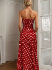Red polka dot strapless maxi dress with a full skirt.