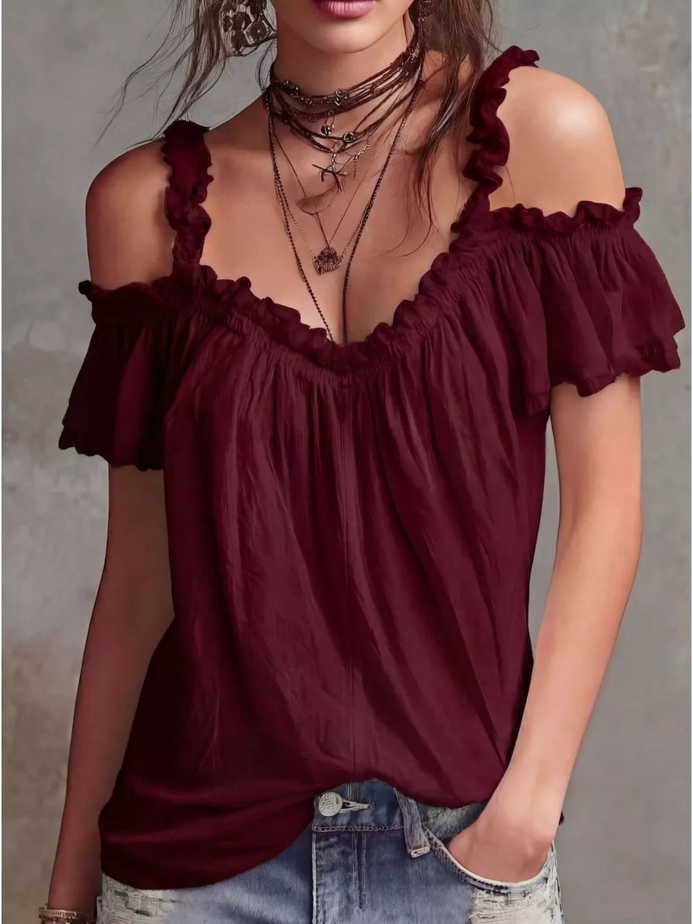 Burgundy ruffled cold shoulder shirt with deep V-neck and short sleeves.