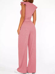 Pink ruffled cap sleeve maternity two-piece set with wide leg pants.