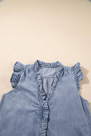 Chambray sleeveless blouse with ruffle trim neckline, placket, and cap sleeves in medium wash cotton.