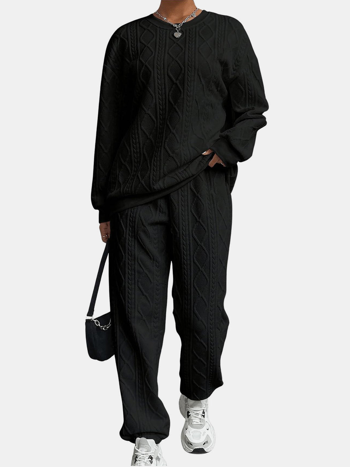 Black cable knit lounge set with crew neck sweatshirt and relaxed fit pants.
