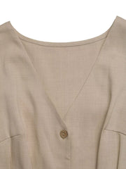 V-neck romper in beige with button detail and pocket detail