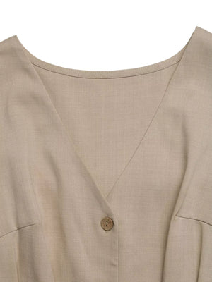 V-neck romper in beige with button detail and pocket detail