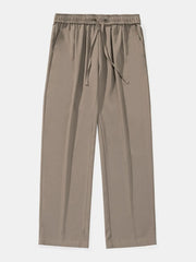 Relaxed palazzo trousers in taupe with elastic drawstring waist and side pockets.