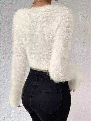 White fluffy V-neck knit sweater with long sleeves and a cropped fit.