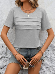 Light gray jersey top with pleated bodice detail and short sleeves.