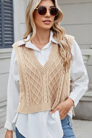Tan cable knit diamond pattern sweater vest with V-neck.