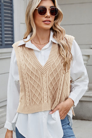 Tan cable knit diamond pattern sweater vest with V-neck.