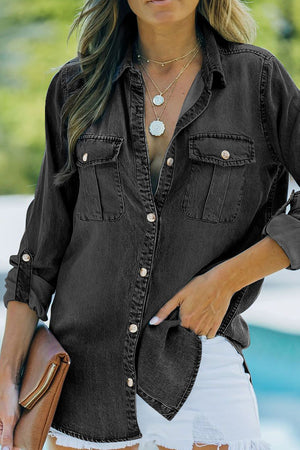 Relaxed black denim shirt with patch pockets, buttoned front, and rolled sleeves.