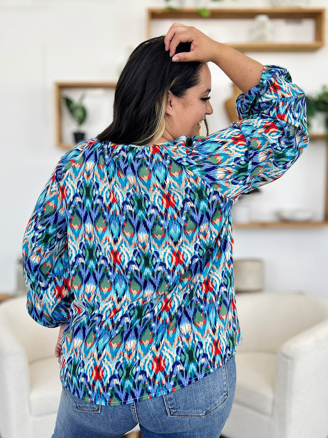 Prismatic ikat blouse with voluminous sleeves in blue and green, featuring a V-neck.
