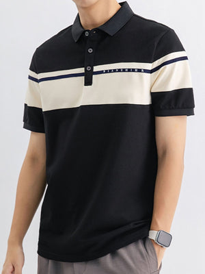 Men's black cotton polo with cream and navy color block detail and embroidered text.