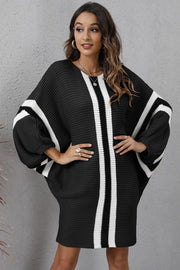 Black oversized knit cocoon dress with white stripes and balloon sleeves.
