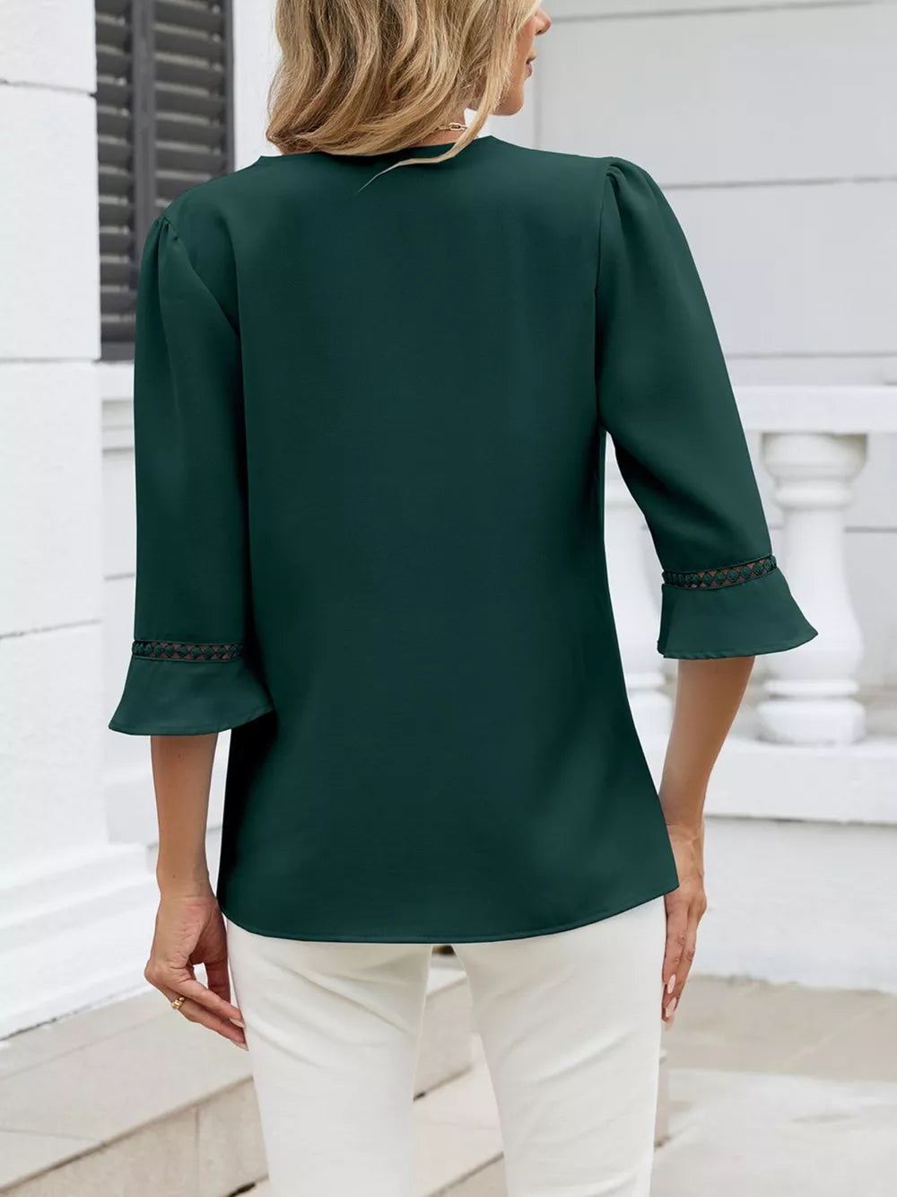 Dark green 3/4 sleeve blouse with lace trim on bell cuffs.
