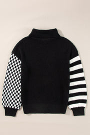 Black knit turtleneck sweater with checkerboard sleeve and striped sleeve