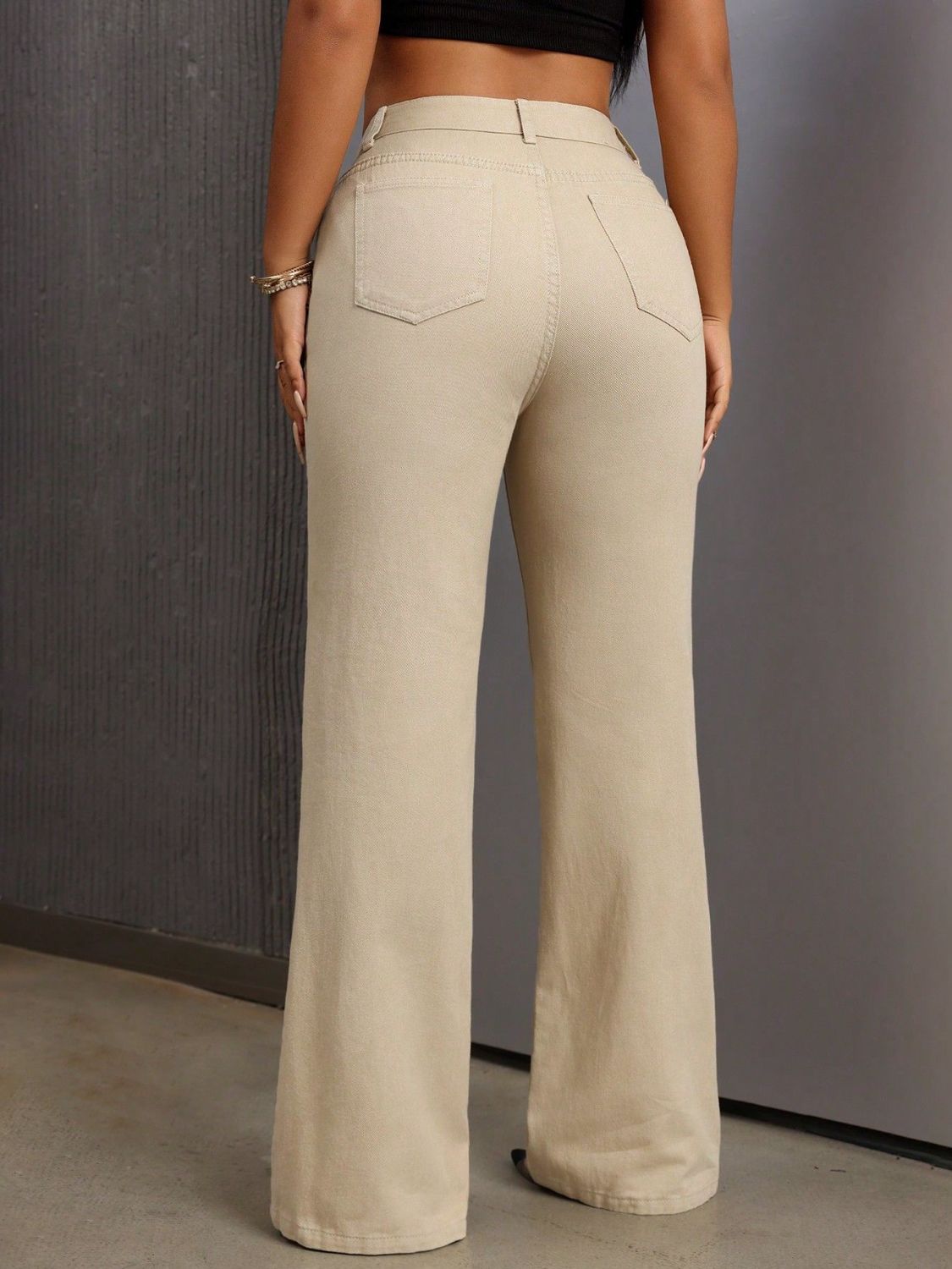 High-waisted flare denim trousers in tan with buttoned closure and back pockets.