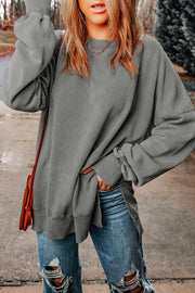 Oversized charcoal washed cotton sweatshirt with crew neck, side slits, and ribbed cuffs.