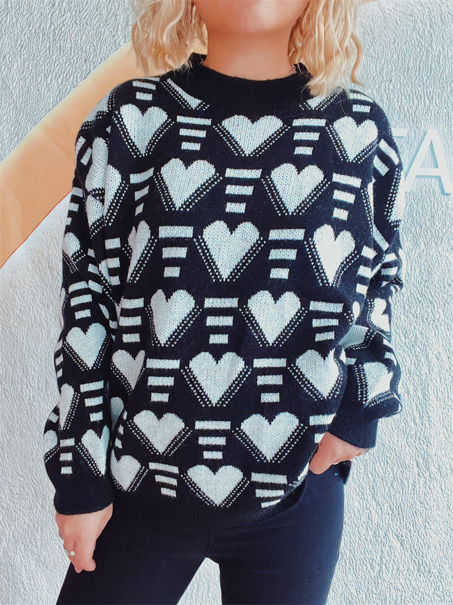 Black acrylic knit jumper with white geometric heart pattern and mock neck.