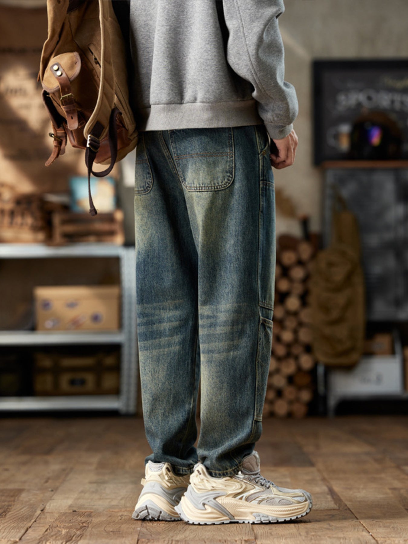 Men's blue straight leg jeans with distressed wash and utility pockets.
