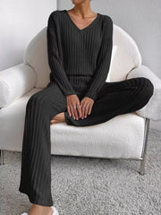 Black ribbed knit V-neck loungewear set with long sleeves and wide-leg pants.