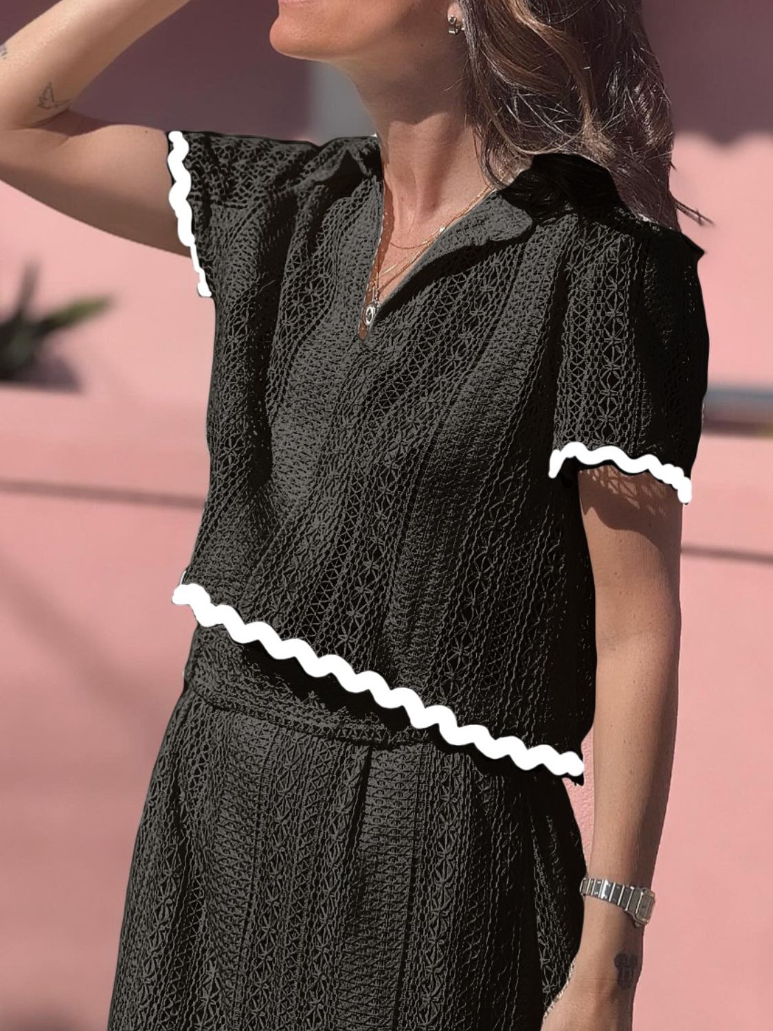 Black crochet co-ord set with scalloped trim on short sleeves and hem