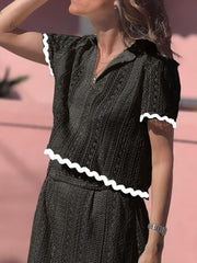 Black crochet co-ord set with scalloped trim on short sleeves and hem