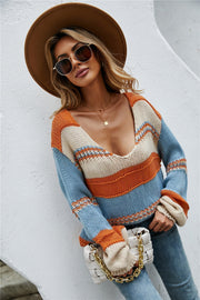 Colorblock knit pullover sweater with deep V-neck and wide sleeves.