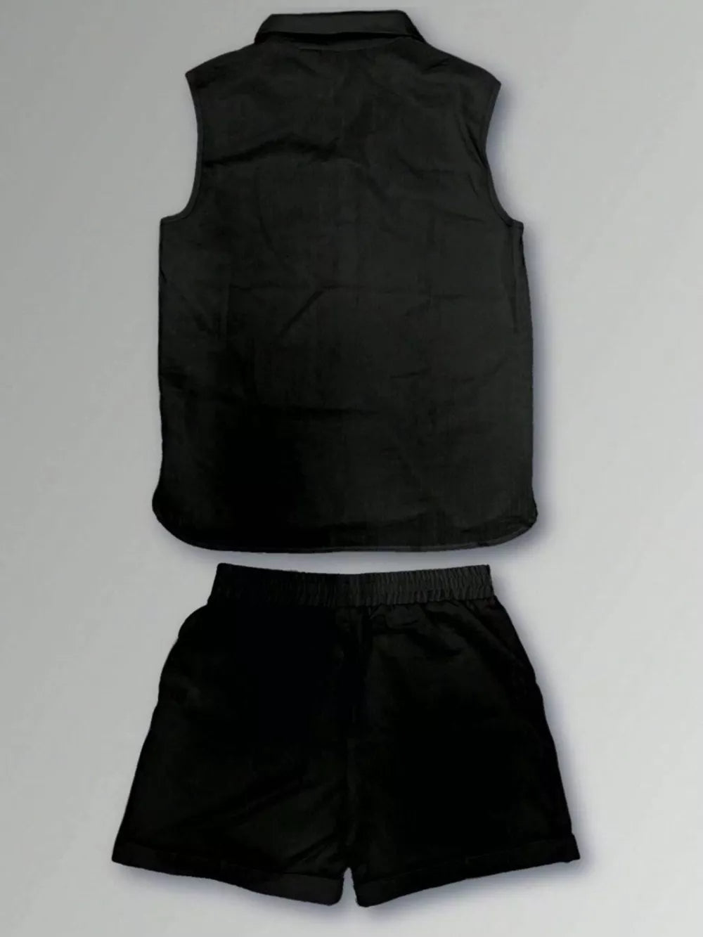 Black sleeveless vest with collar and matching shorts.