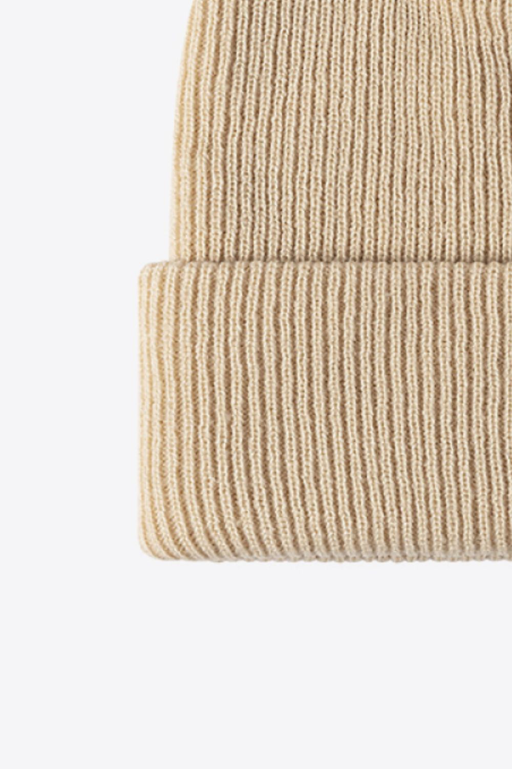 Beige ribbed knit beanie with a cuffed hem.