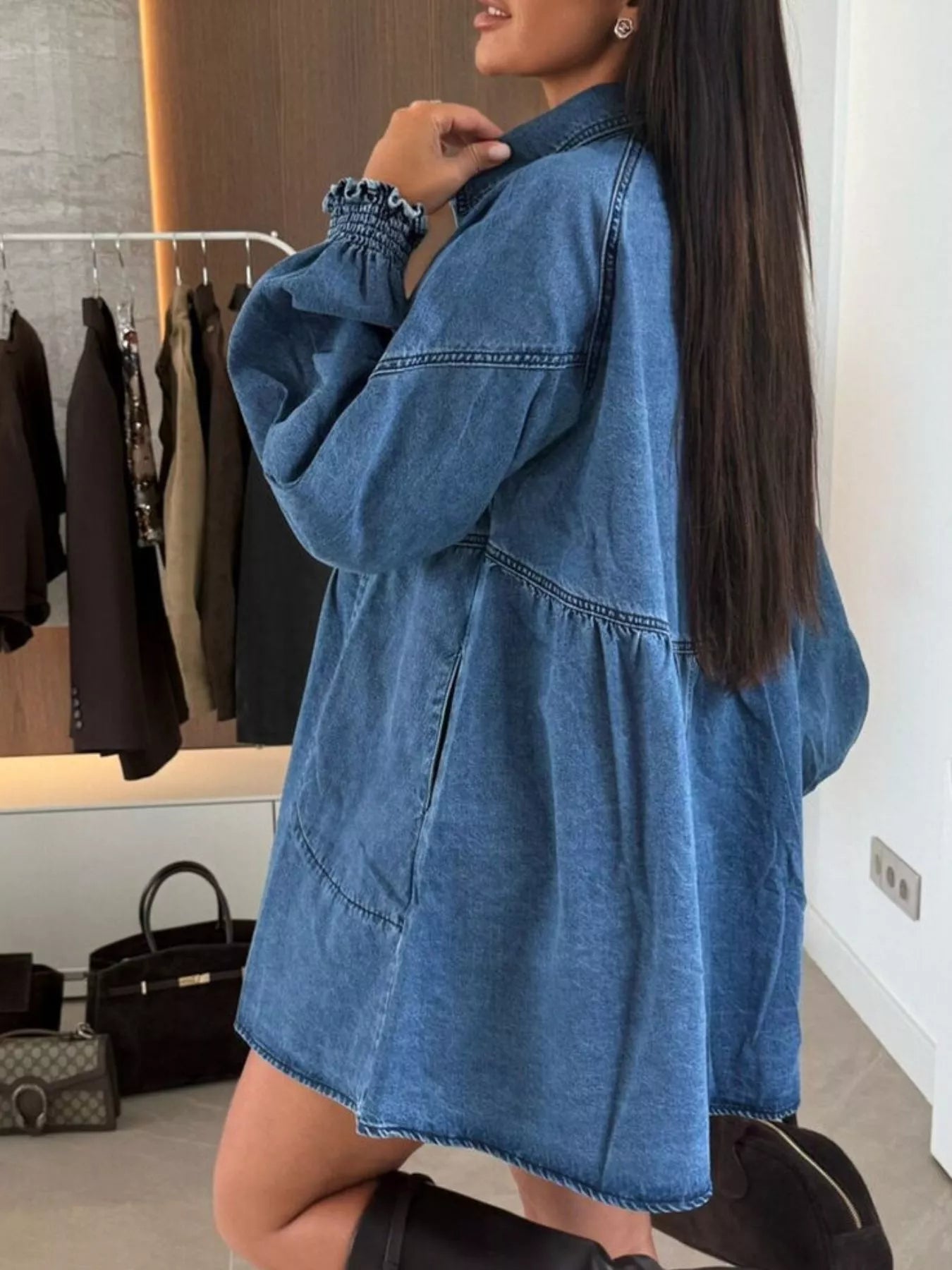 Blue denim mini dress with pockets and ruffled cuffs.