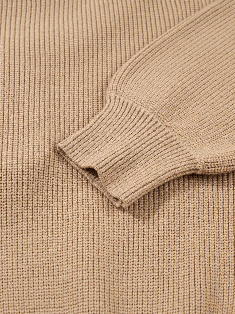 Ribbed knit sweater dress in beige with a close-up view of the sleeve cuff detail.
