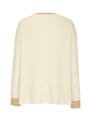 Waffle knit raglan sleeve sweatshirt in cream with tan cuffs and neckline detail.