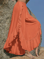 Ochre palazzo pants with ruffled hemline and split leg detail.
