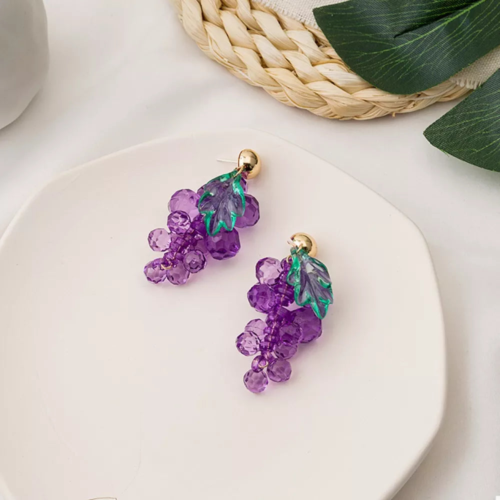 Grape-inspired beaded dangle earrings with purple acrylic beads and green leaves.