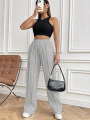 Gray pleated wide-leg lounge trousers with drawstring waist and a relaxed fit.