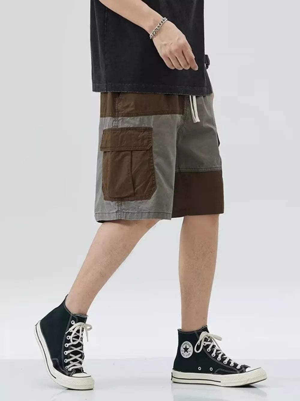 Two-tone cargo shorts with drawstring and patch pockets, above knee length.