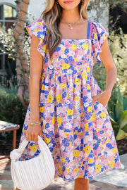 Floral flutter sleeve mini dress with pockets in cotton blend, featuring a square neckline and vibrant floral print.