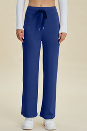 Blue wide leg lounge pants with drawstring waist and flared hem
