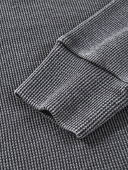Dark gray waffle knit oversized sweatshirt with ribbed cuffs and hem detail.