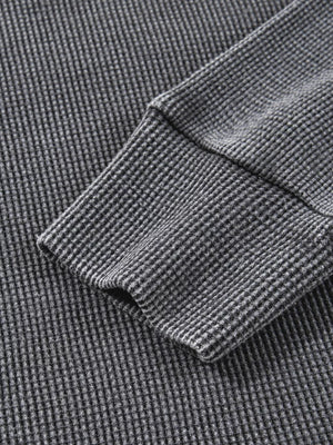 Dark gray waffle knit oversized sweatshirt with ribbed cuffs and hem detail.