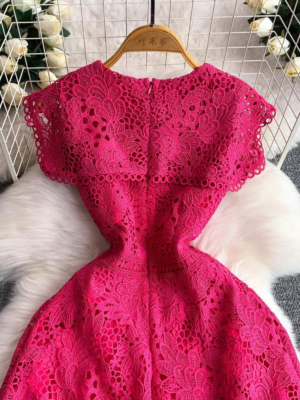 Fuchsia pink lace A-line dress with cap sleeves and cutout detail.