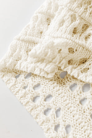Ivory openwork knit pullover with balloon sleeves and textured detail.